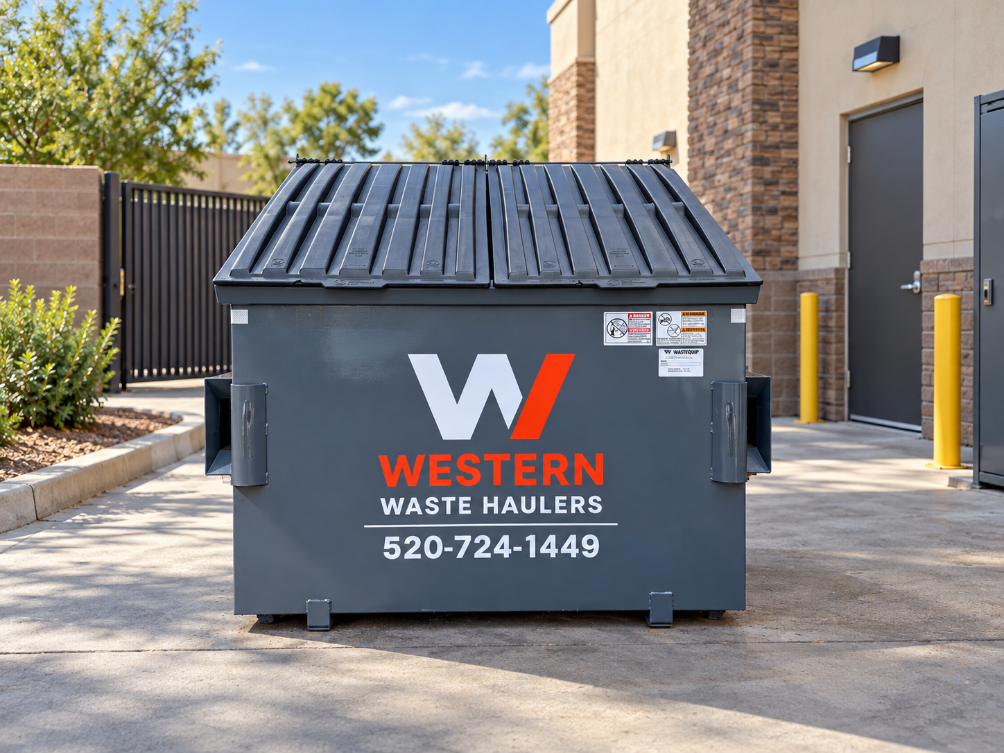 Western Waste Haulers branded front-load dumpster outside a commercial property in Tucson